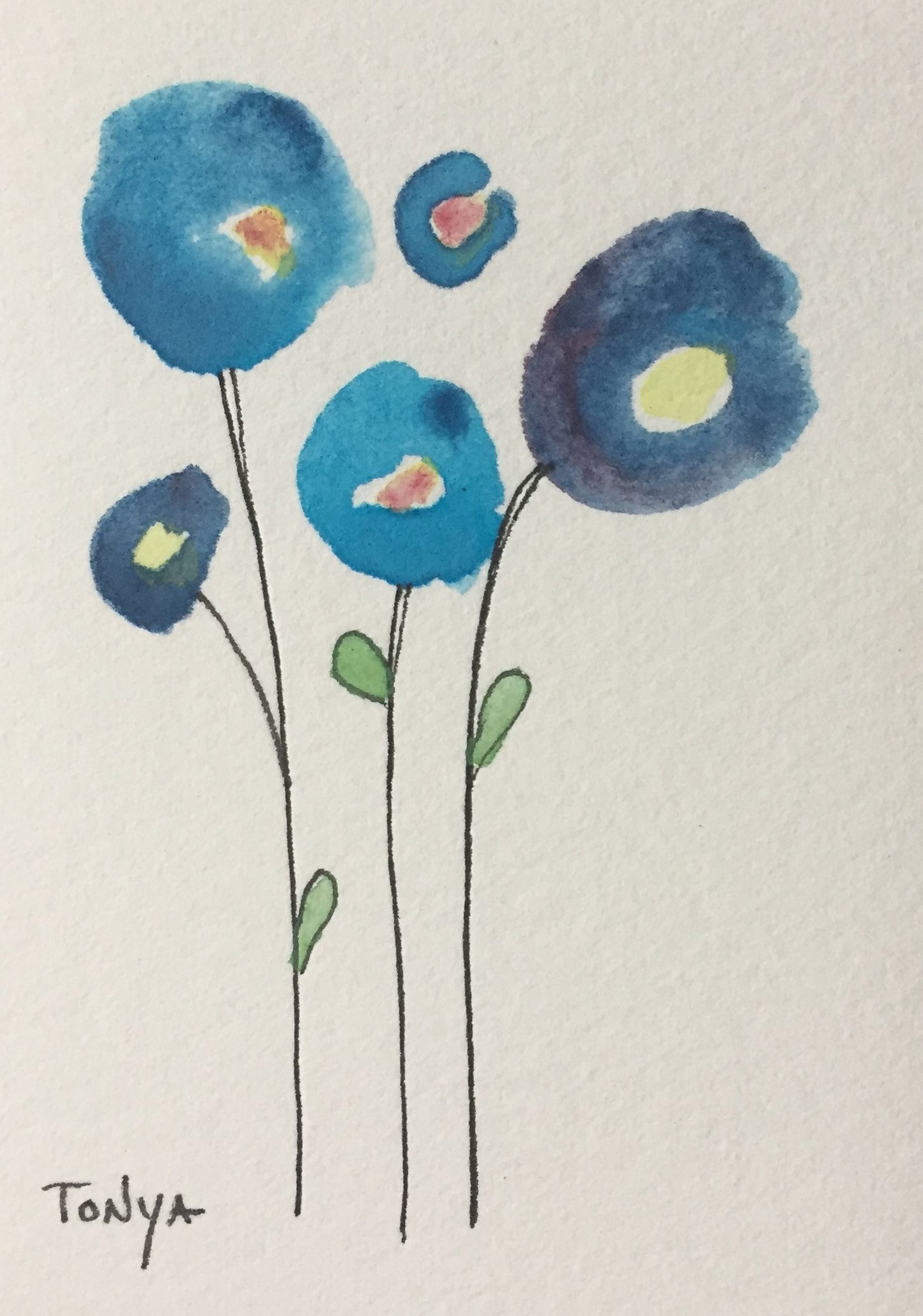 A miniature watercolor painting of three blue abstract-style wildflowers with the artist's signature, presented on a white background. By Artist Tonya Henderson.