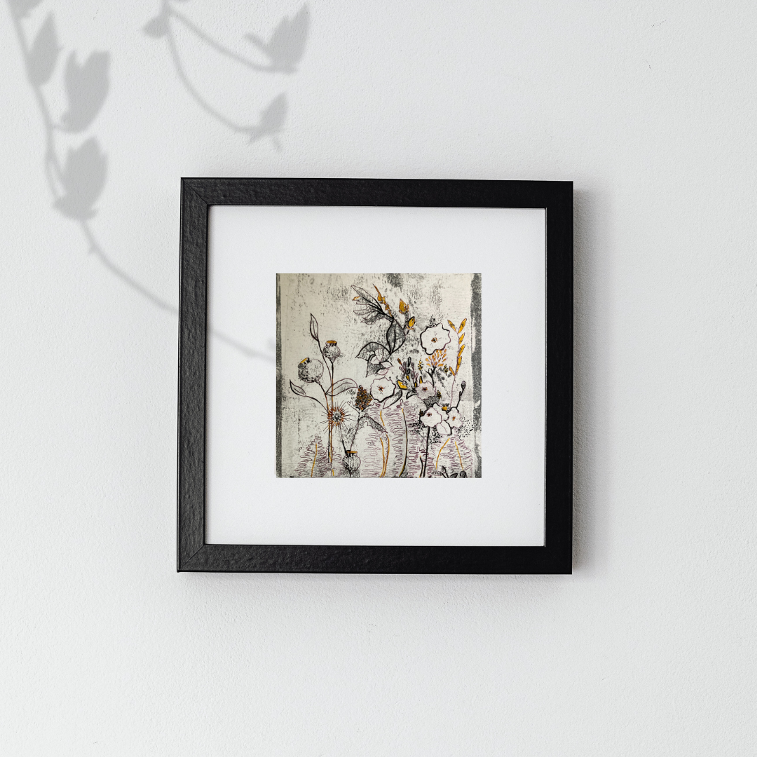 Mixed media nature painting by Tonya Henderson in black with gold accents hanging on a light background.
