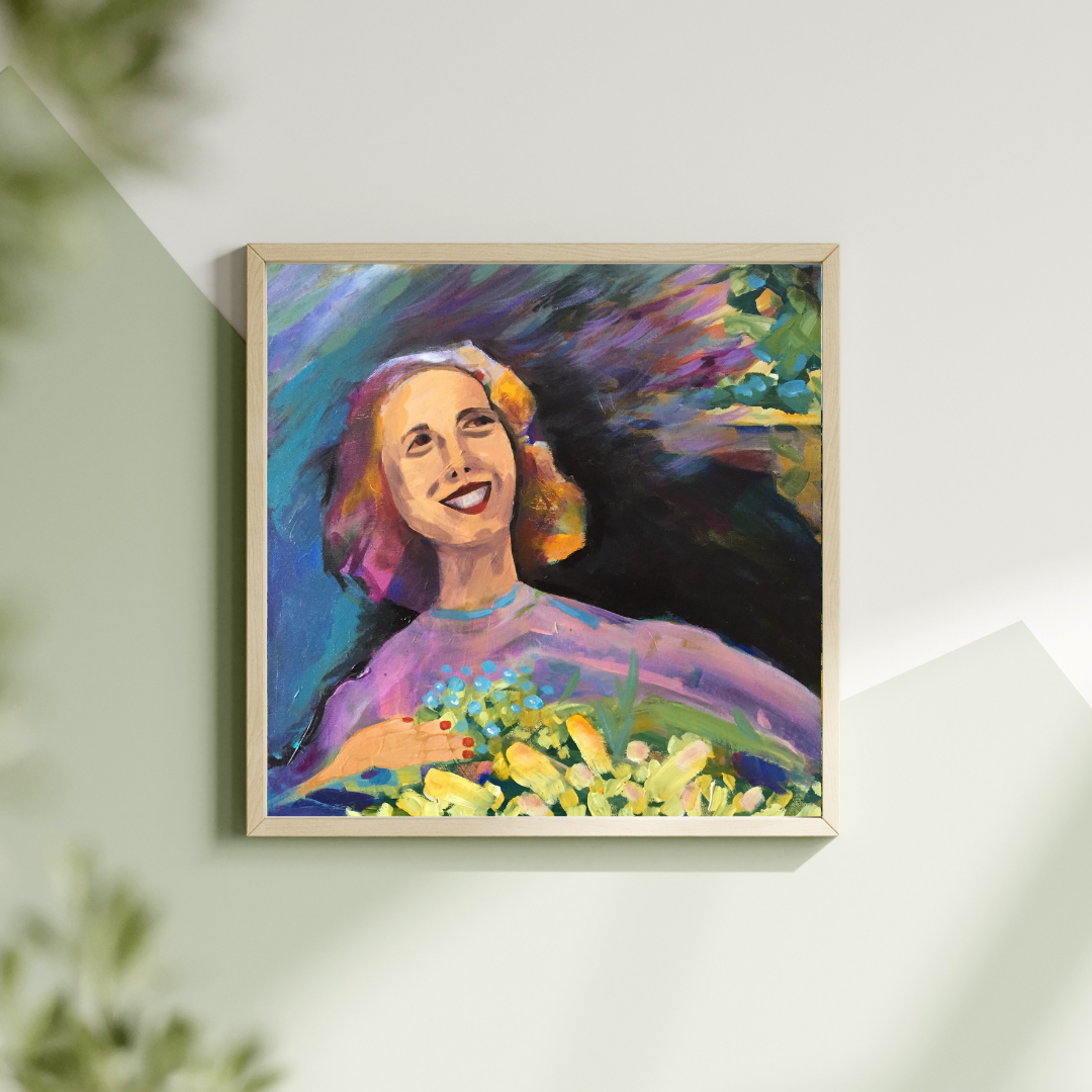 Framed colorful painting of a smiling woman with flowers on a white wall by artist Tonya Henderson.