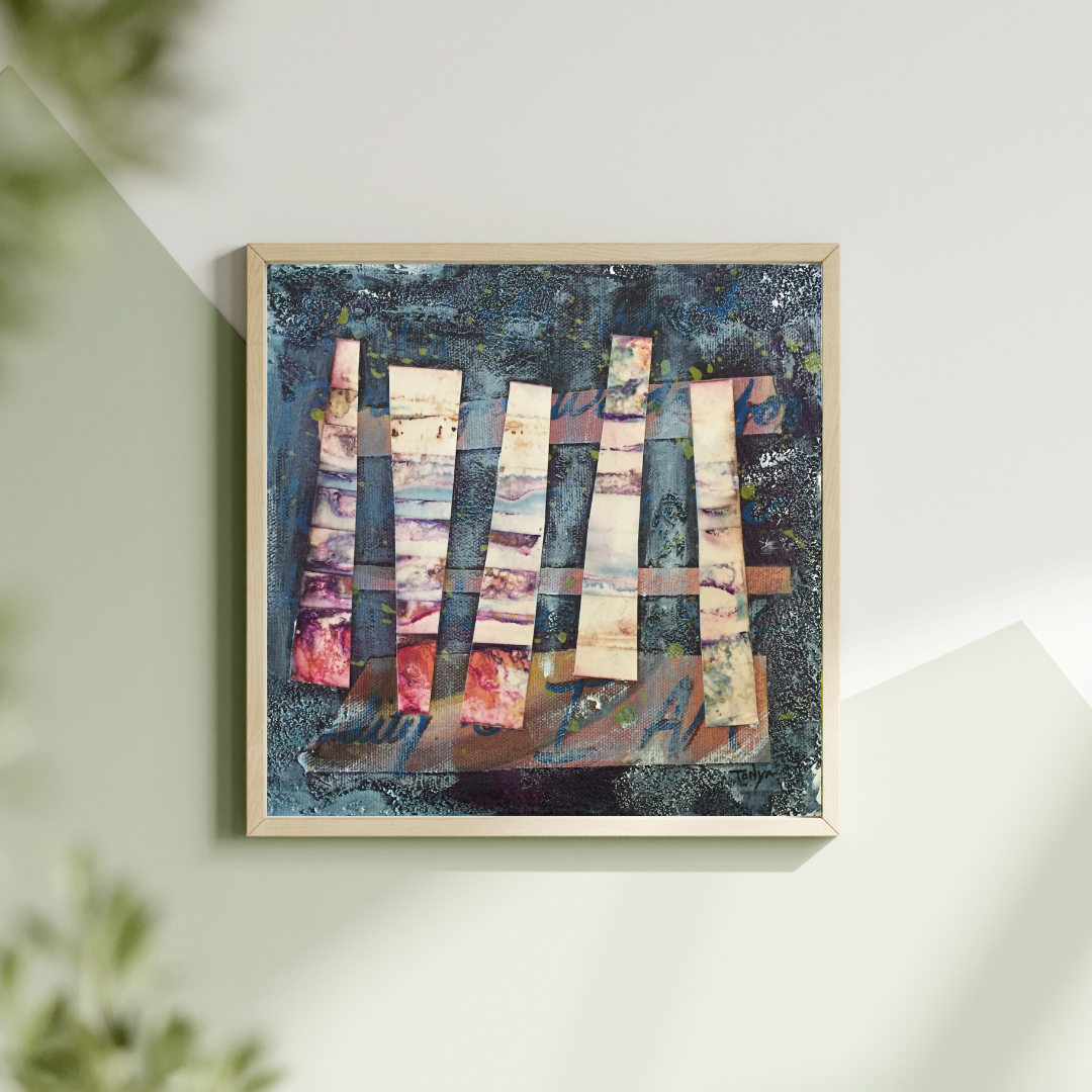 Framed abstract artwork with colorful geometric shapes on a dark blue background and hanging on a light green wall by artist Tonya Henderson.