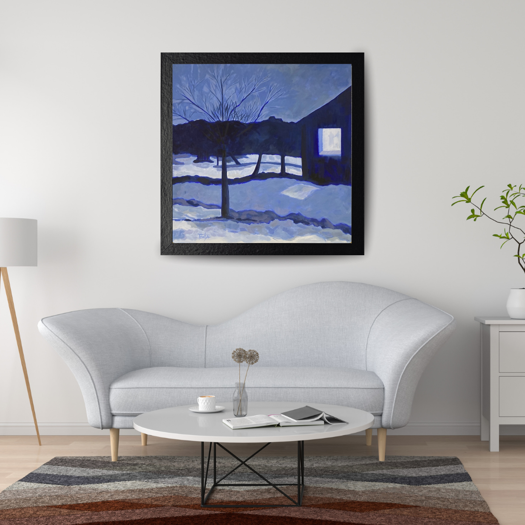Framed acrylic landscape painting of evening snow by artist Tonya Henderson above a white sofa in a living room setting.