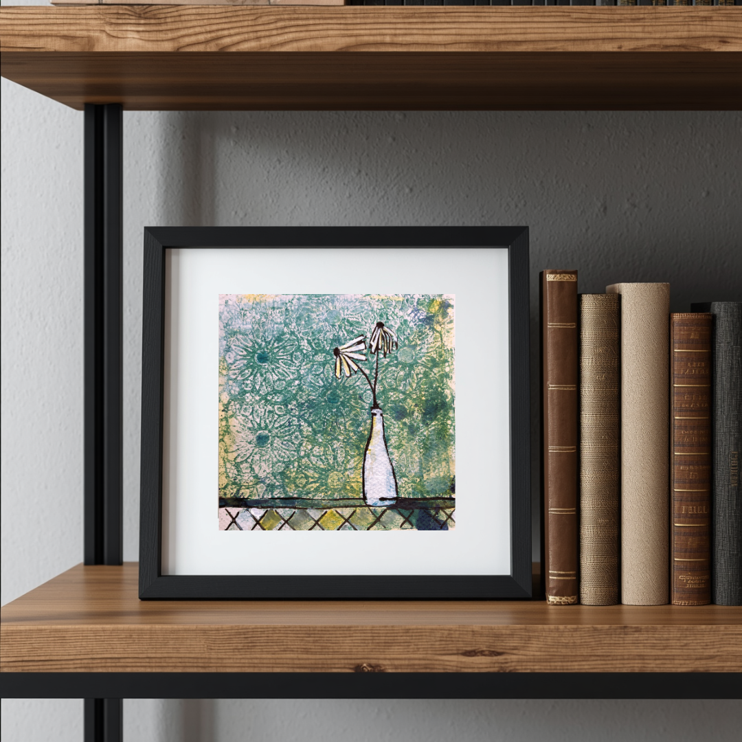 Framed artwork on a wooden shelf with books