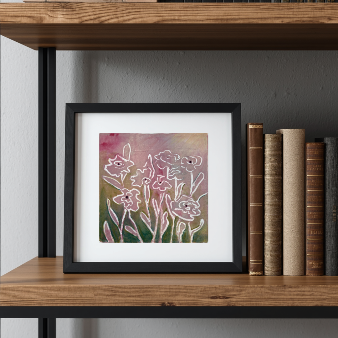 Framed floral artwork on a wooden shelf with books