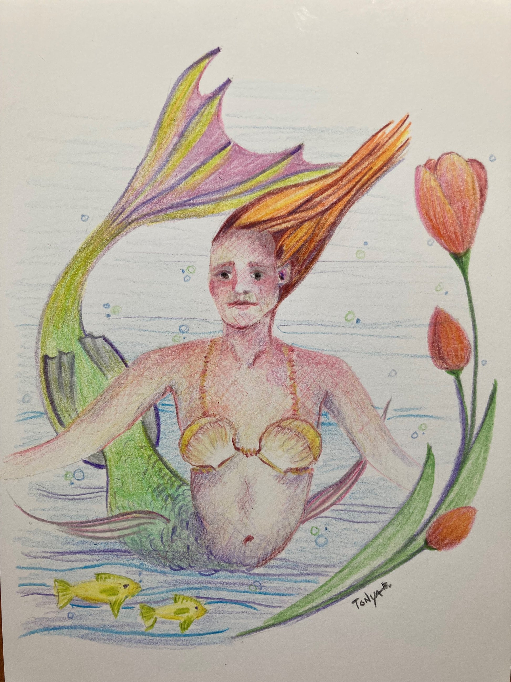 A colored pencil drawing of a Mermaid, two yellow fish, and red tulips flowing around them.