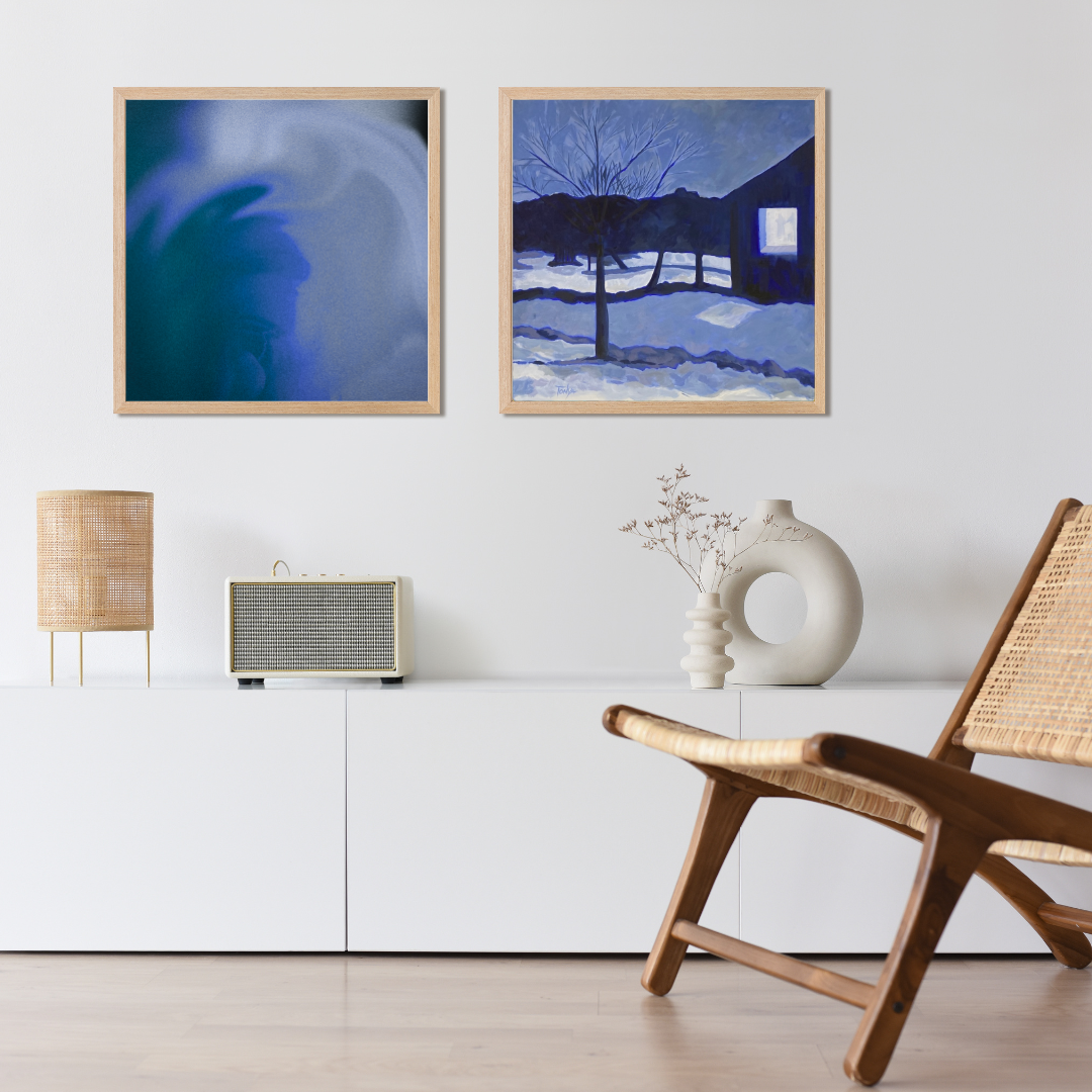 Modern living room with framed artwork, a chair, and a lamp.