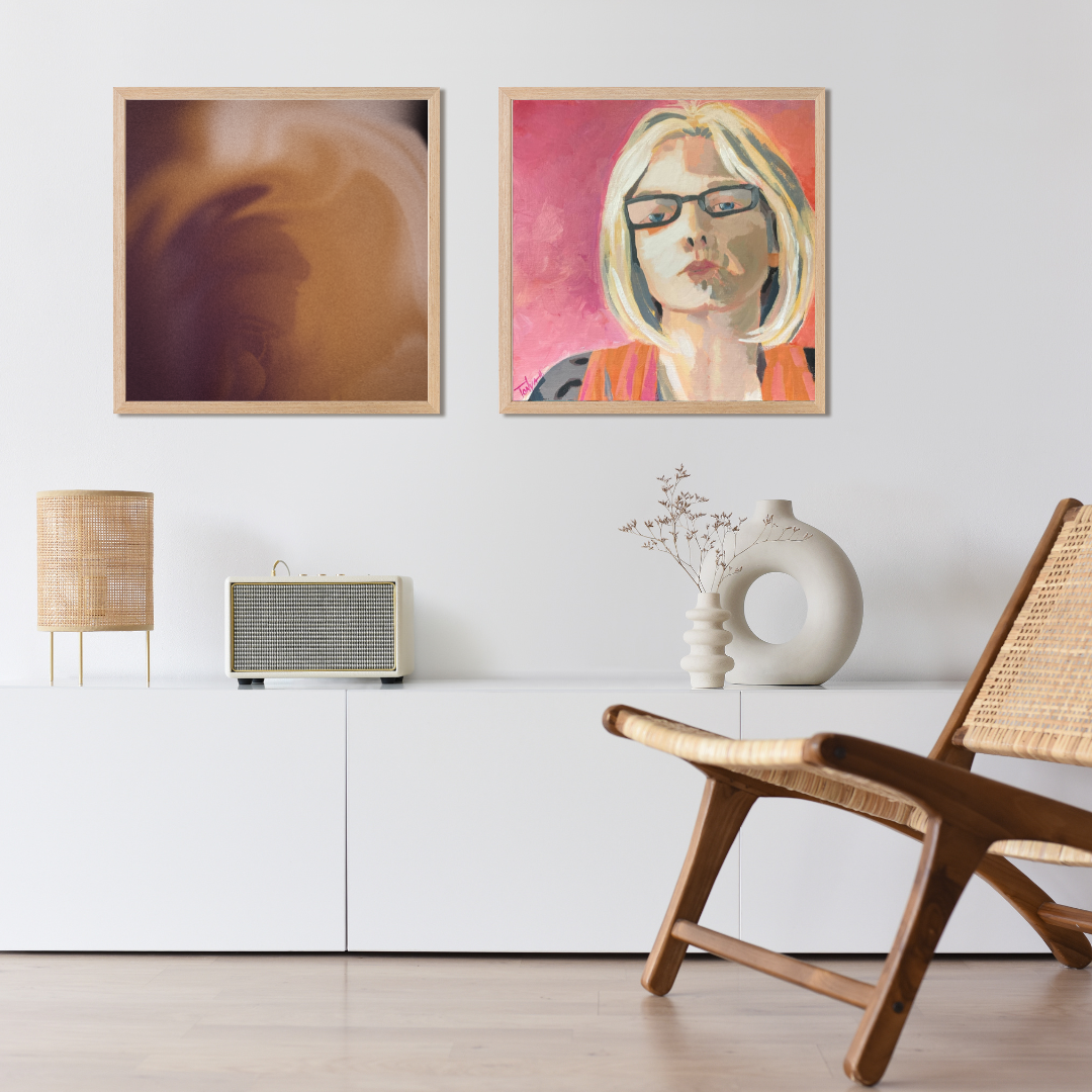 Modern living room with framed artwork, a chair, and a lamp.